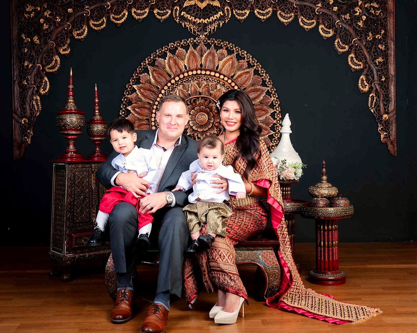 Ben and Ploy Cunningham with their sons in traditional Thai dress