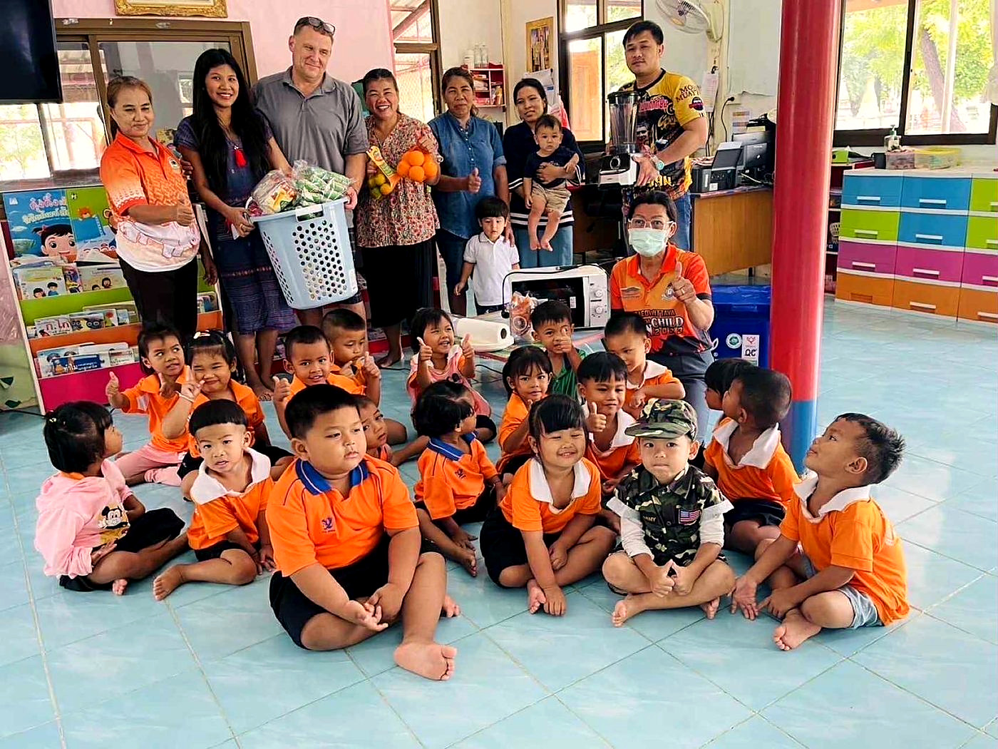 Ben and Ploy delivering supplies to a village preschool in Surin