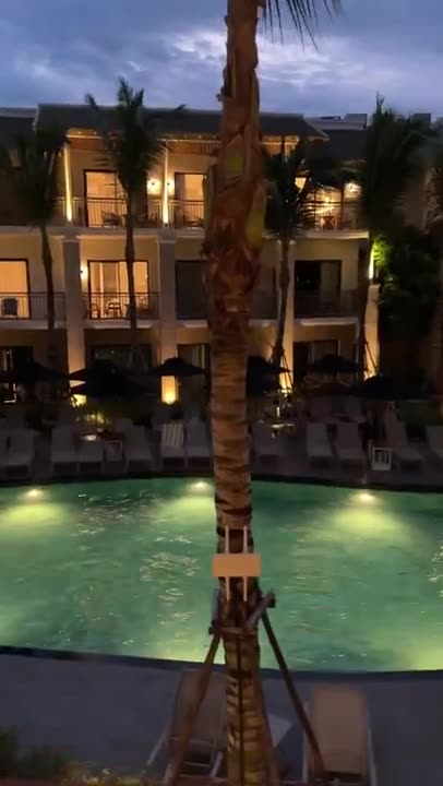 The resort grounds and lit pool at dusk
