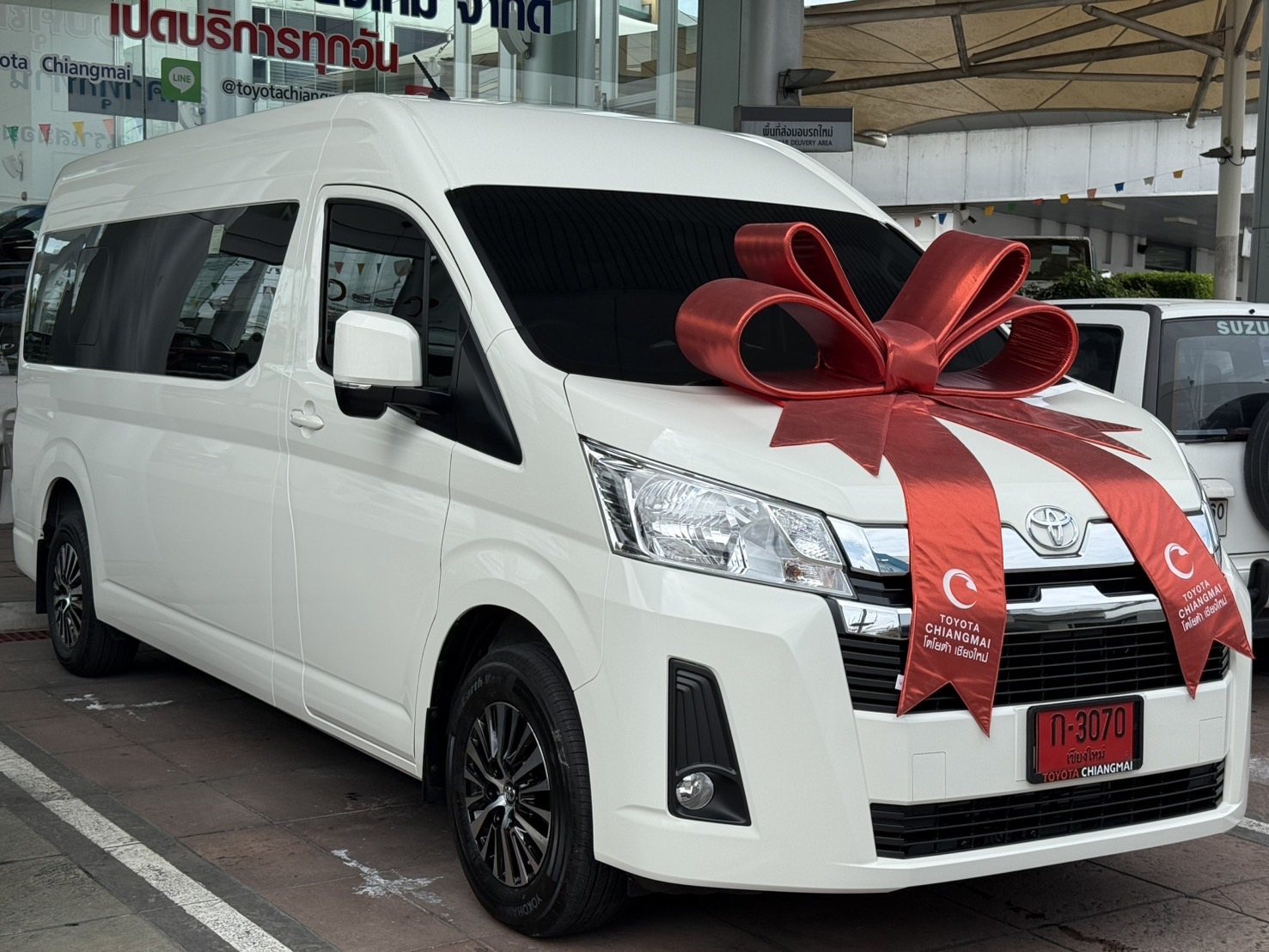 The family's white Toyota Hiace van in Chiang Mai